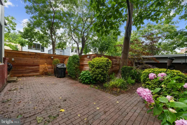 a garden with trees in front of it