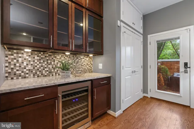 a kitchen with granite countertop wooden cabinets and a wooden floor
