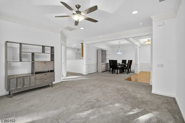 an empty room with a window and a ceiling fan