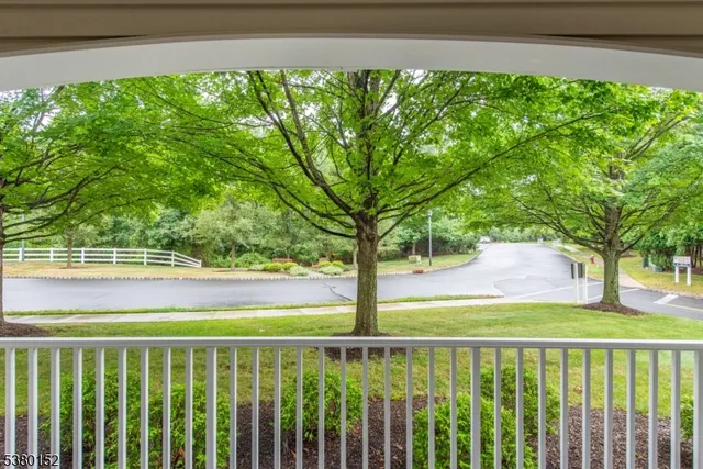 an empty room with a window and a chandelier fan