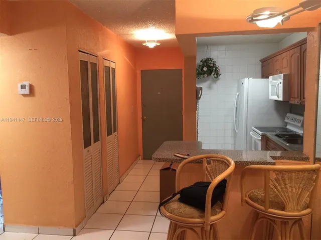 a view of a bathroom with a bathtub and a mirror