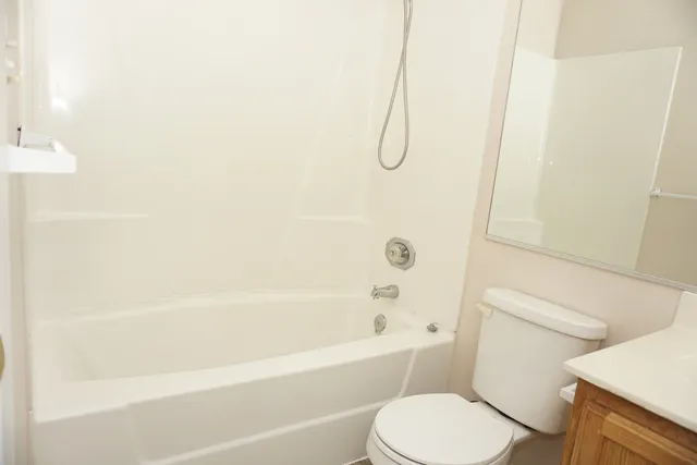 a bathroom with a bath tub with a shower