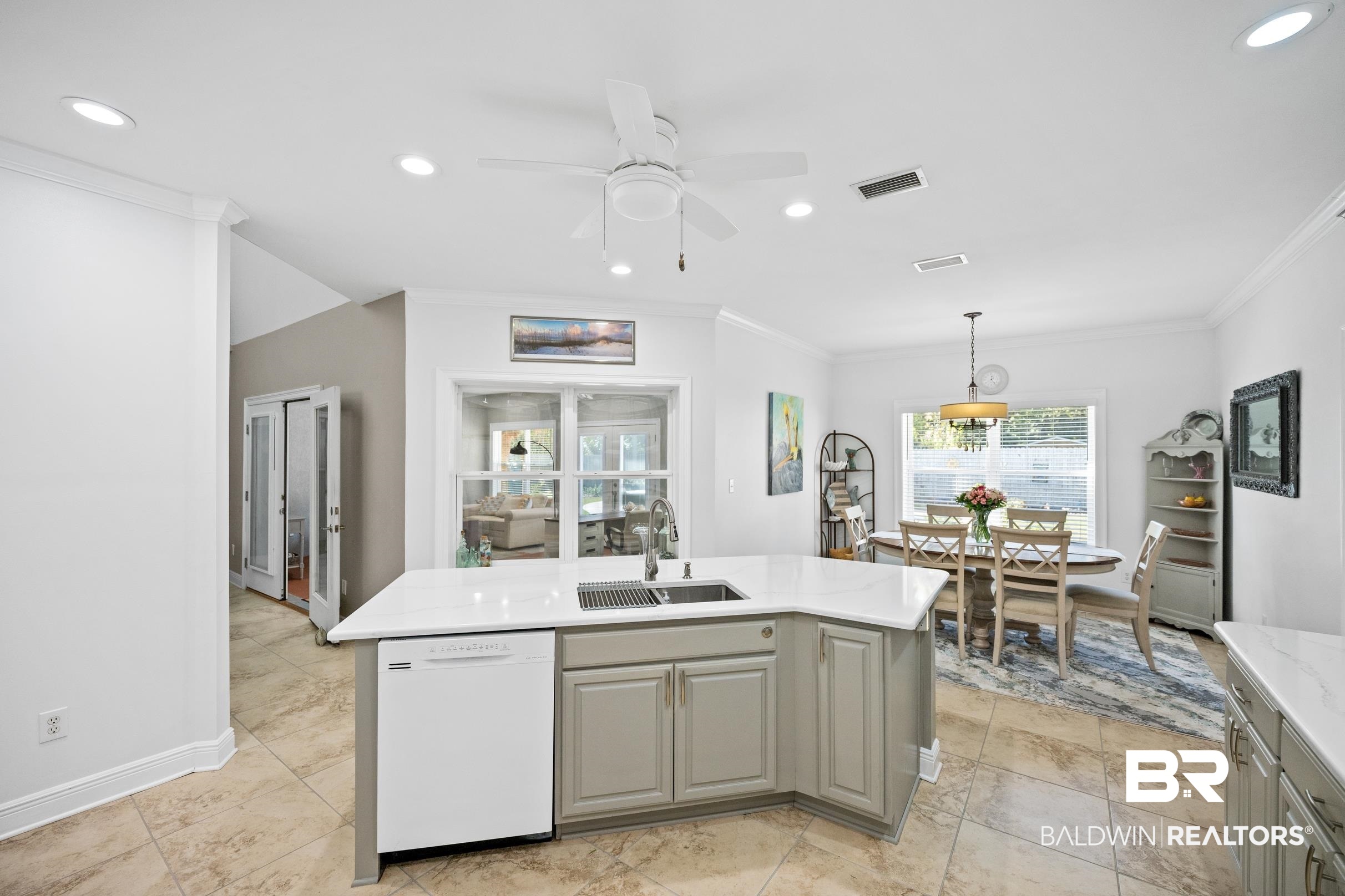 5217 Greentree Road Orange Beach, AL 36561 - Photo 13 of 58 Kitchen featuring gray cabinets, dishwasher, crown molding, hanging light fixtures, and an island with sink