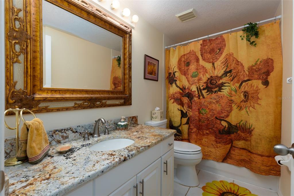 9341 Blind Pass Road St. Pete Beach, FL 33706 - Photo 13 of 44 a bathroom with a granite countertop sink and a mirror