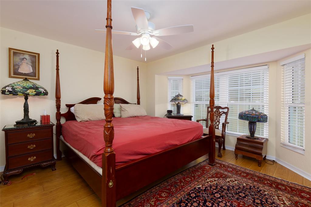 9341 Blind Pass Road St. Pete Beach, FL 33706 - Photo 14 of 44 a bed room with a bed and a chandelier