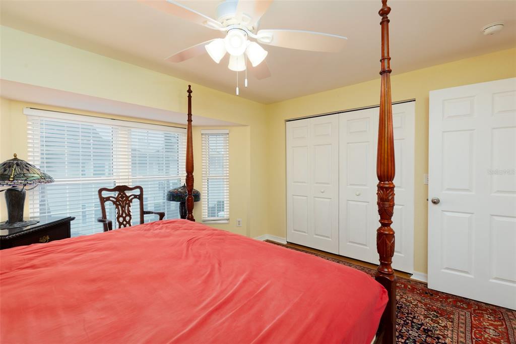 9341 Blind Pass Road St. Pete Beach, FL 33706 - Photo 15 of 44 a bed room with a bed and a chandelier