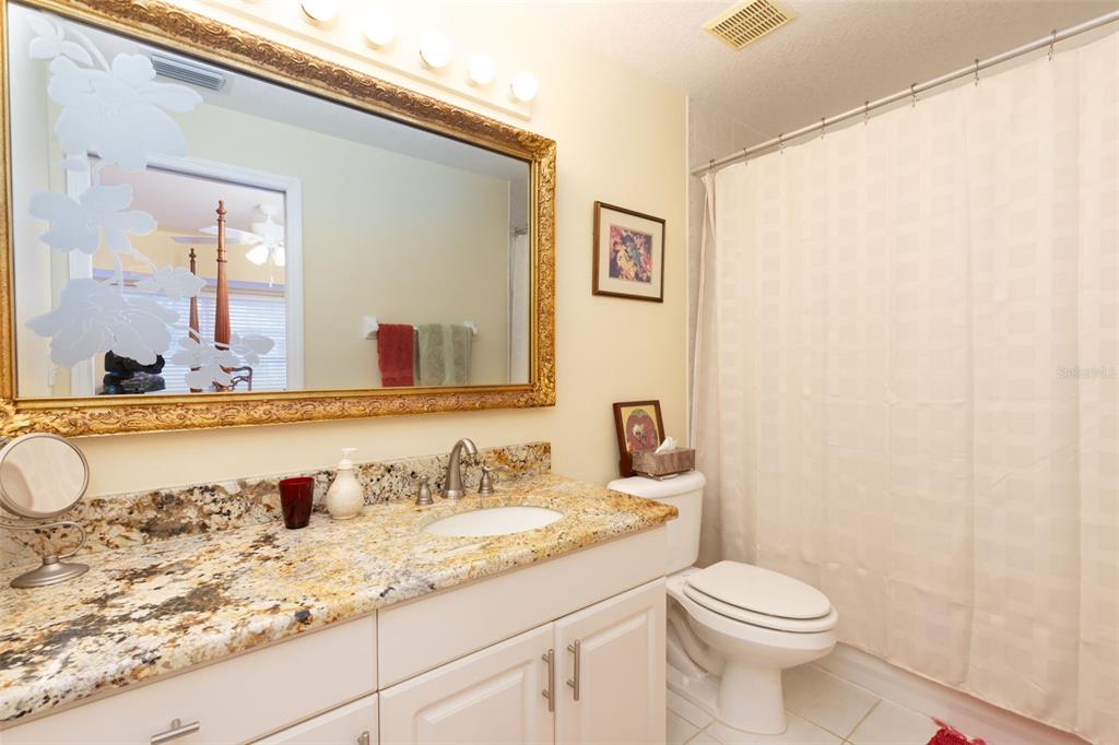 9341 Blind Pass Road St. Pete Beach, FL 33706 - Photo 16 of 44 a bathroom with a granite countertop sink and a mirror