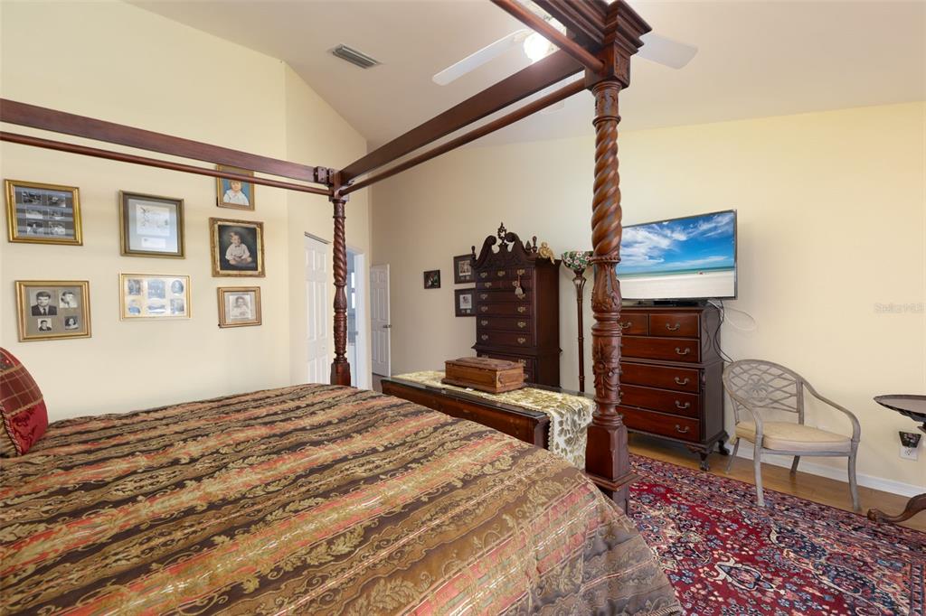 9341 Blind Pass Road St. Pete Beach, FL 33706 - Photo 19 of 44 a bedroom with a bed dresser and a window