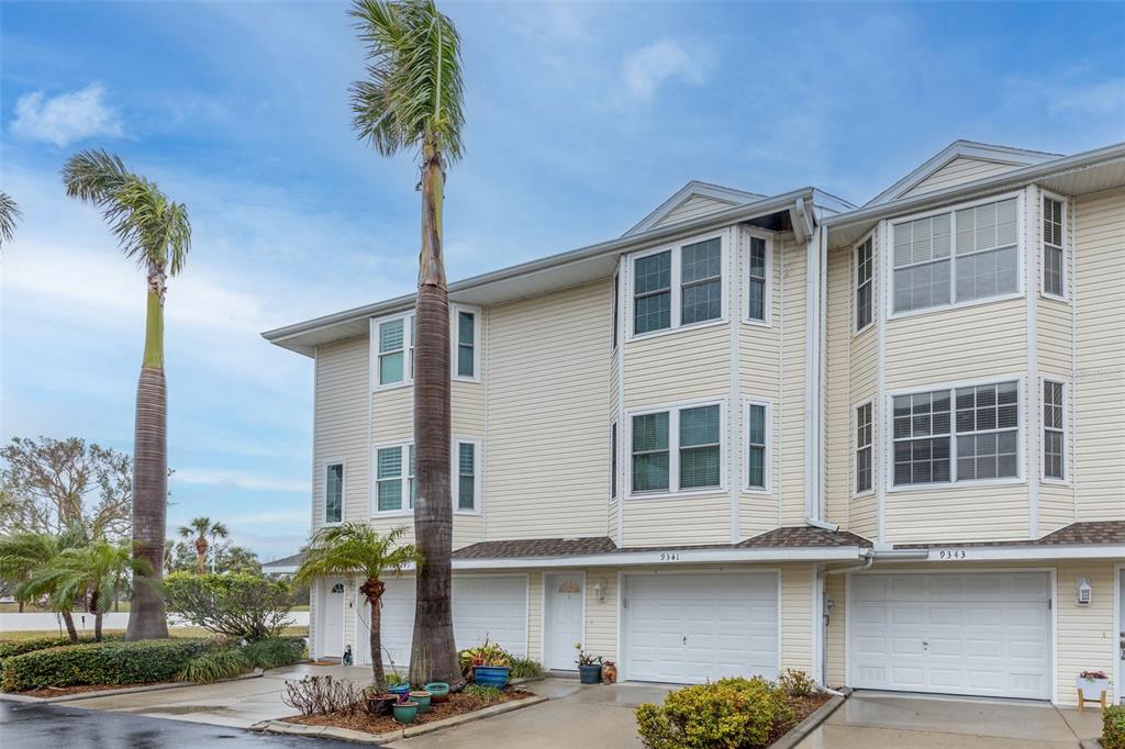 9341 Blind Pass Road St. Pete Beach, FL 33706 - Photo 2 of 44 a front view of a building with glass windows