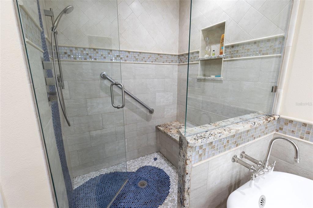 9341 Blind Pass Road St. Pete Beach, FL 33706 - Photo 22 of 44 a bathroom with a sink toilet and shower