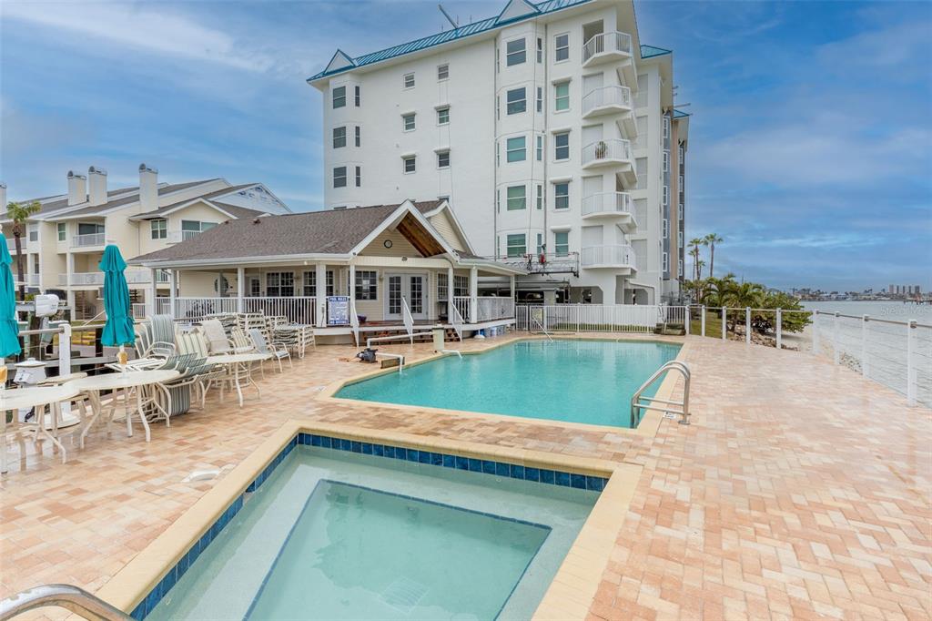 9341 Blind Pass Road St. Pete Beach, FL 33706 - Photo 37 of 44 a view of a patio with a table and chairs