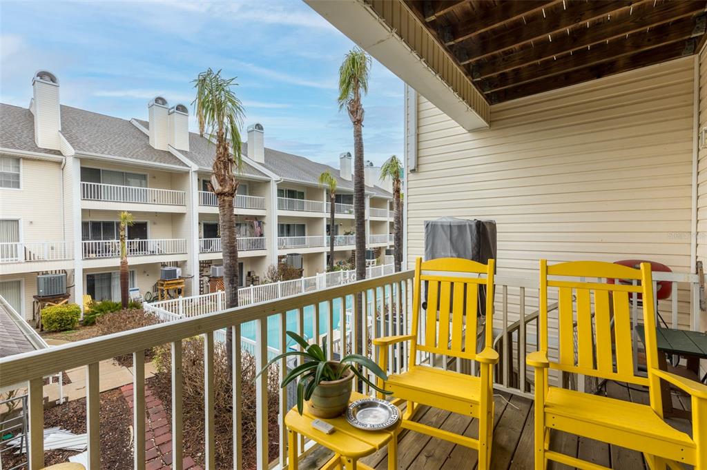 9341 Blind Pass Road St. Pete Beach, FL 33706 - Photo 6 of 44 a view of a blue swimming pool with a balcony