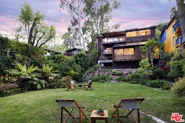 a backyard of a house with a garden and plants
