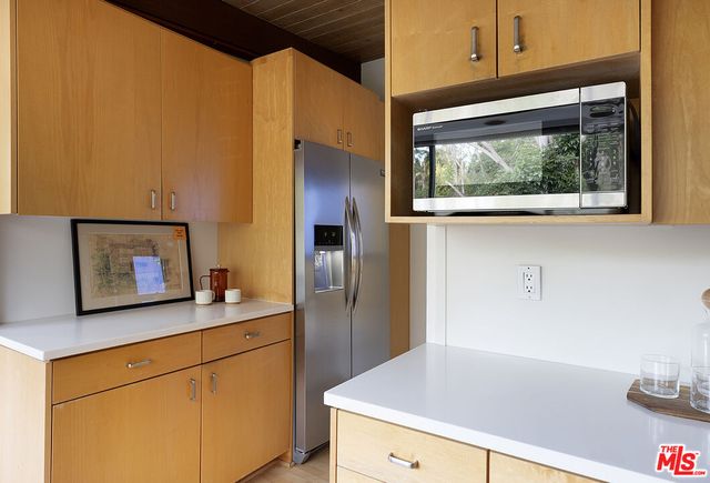 a kitchen with a stove a sink and a table