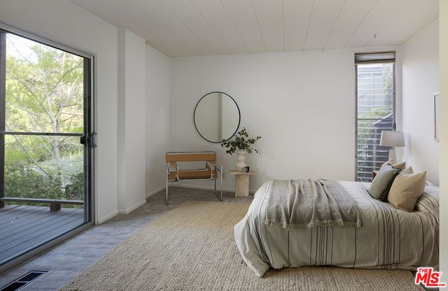 a bedroom with a bed and a table