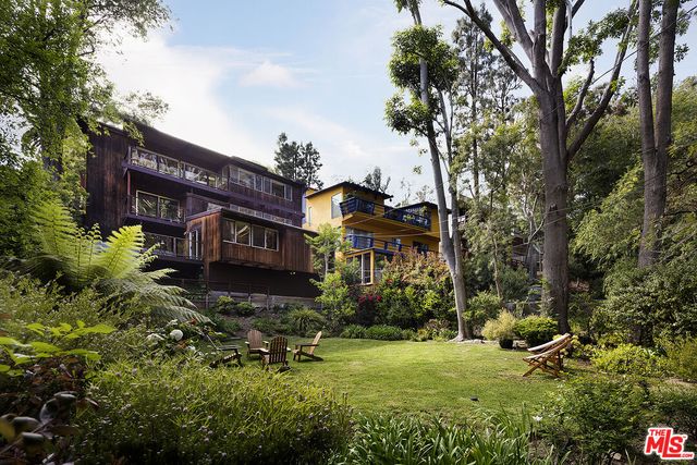 an aerial view of a house with a yard and garden