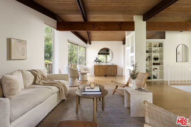 a living room with furniture a fireplace and a large window