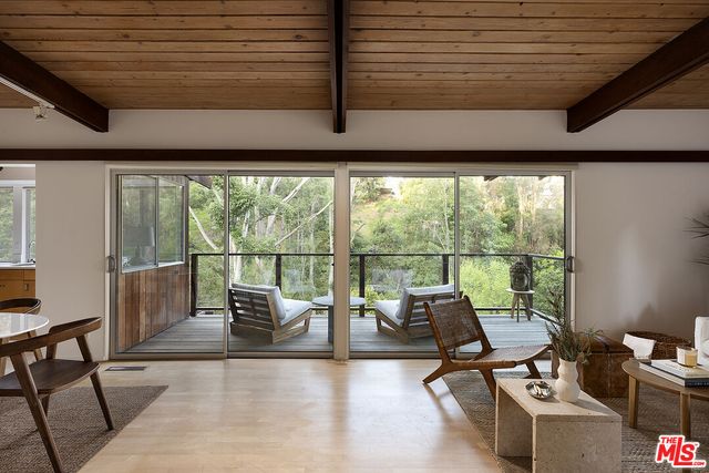 a living room with furniture and floor to ceiling windows