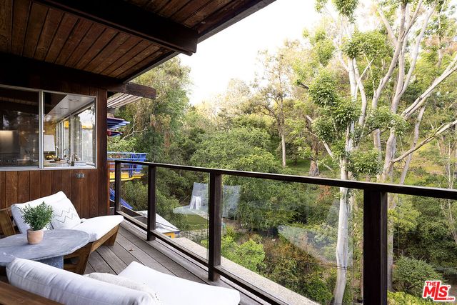 a view of a porch with furniture and wooden deck