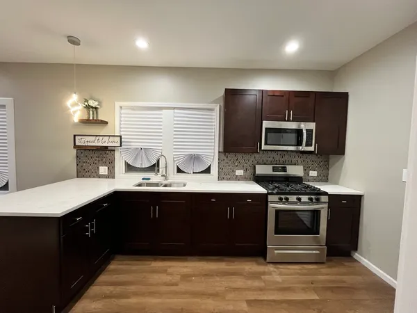 a kitchen with a sink and stainless steel appliances