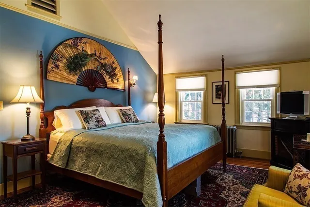 a bedroom with a bed and a flat screen tv