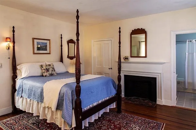 a bedroom with a bed and a fireplace
