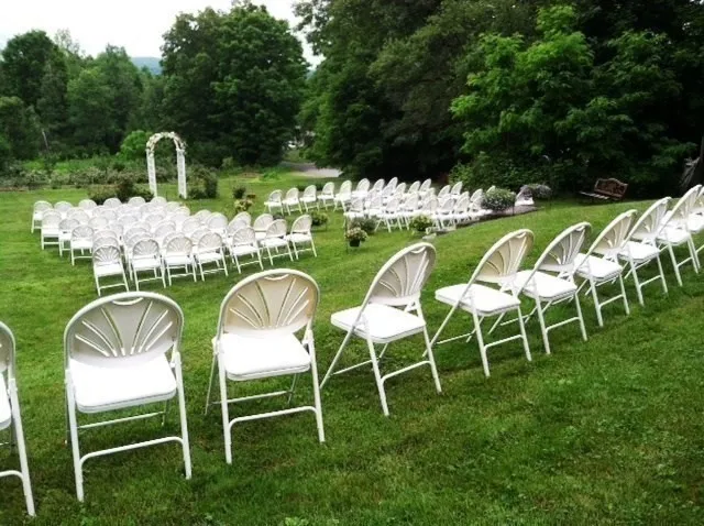 a backyard of a house with table and chairs