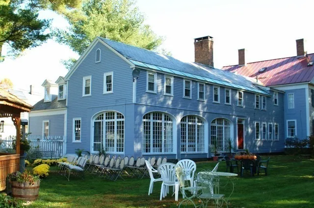 a front view of a house with a yard table and chairs