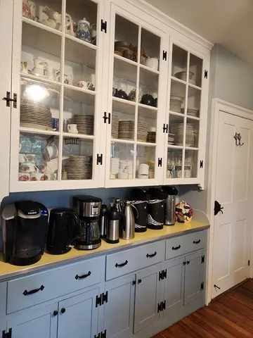 a kitchen with granite countertop white cabinets and window
