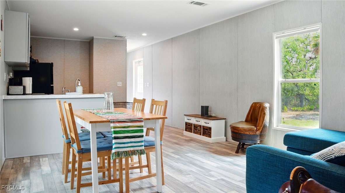 545 South Estribo Street Clewiston, FL 33440 - Photo 13 of 13 a view of a dining room with furniture window and wooden floor