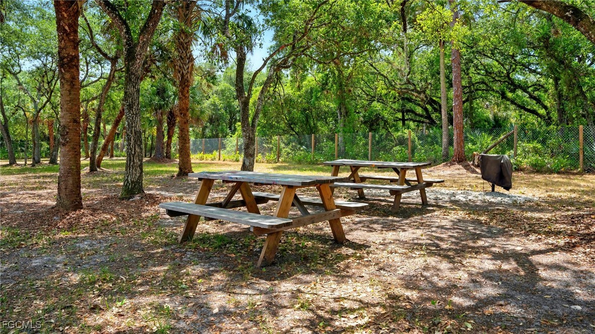 545 South Estribo Street Clewiston, FL 33440 - Photo 7 of 13 a view of a bench in a backyard