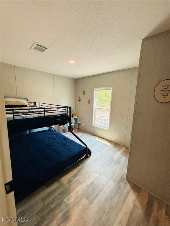 545 South Estribo Street Clewiston, FL 33440 - Photo 10 of 13 a bedroom with a bed and dresser