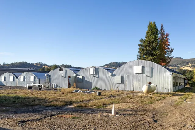 a view of a white house with a yard