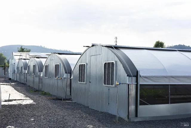 a view of a white house with a outdoor space