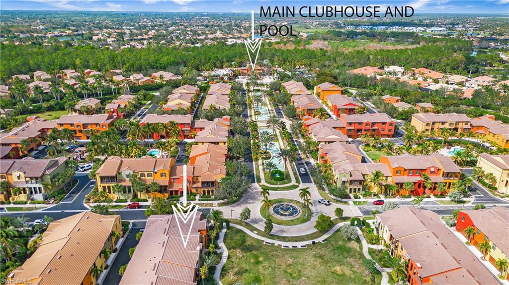 an aerial view of a city with lots of residential buildings ocean and mountain view in back