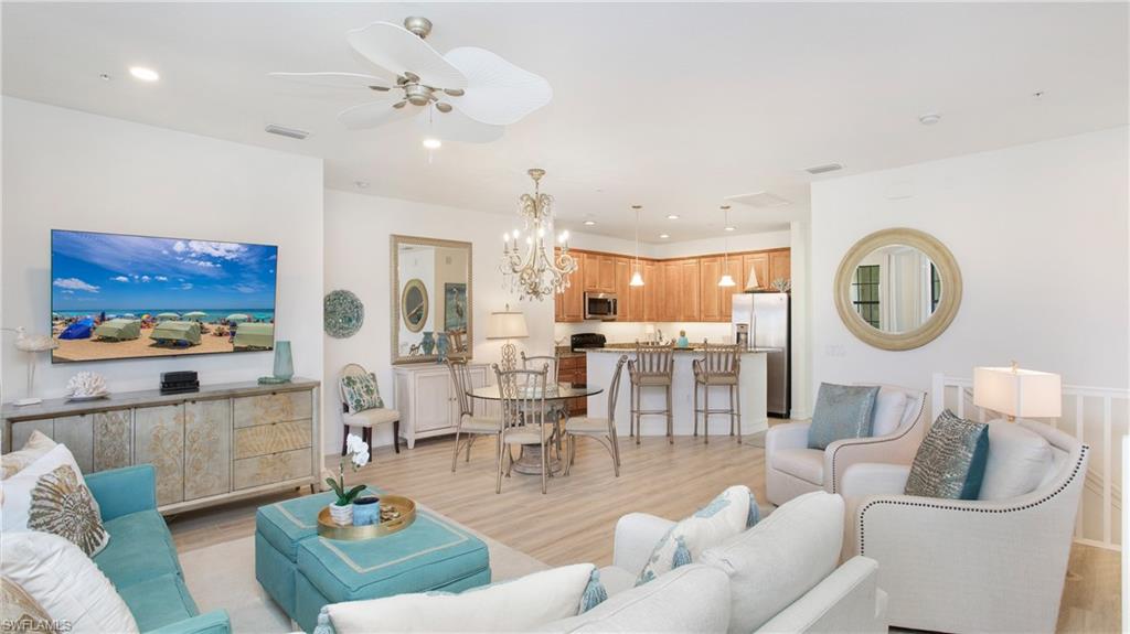 9078 Albion Lane South, Unit 6603 Naples, FL 34113 - Photo 7 of 41 a living room with furniture a rug and white walls