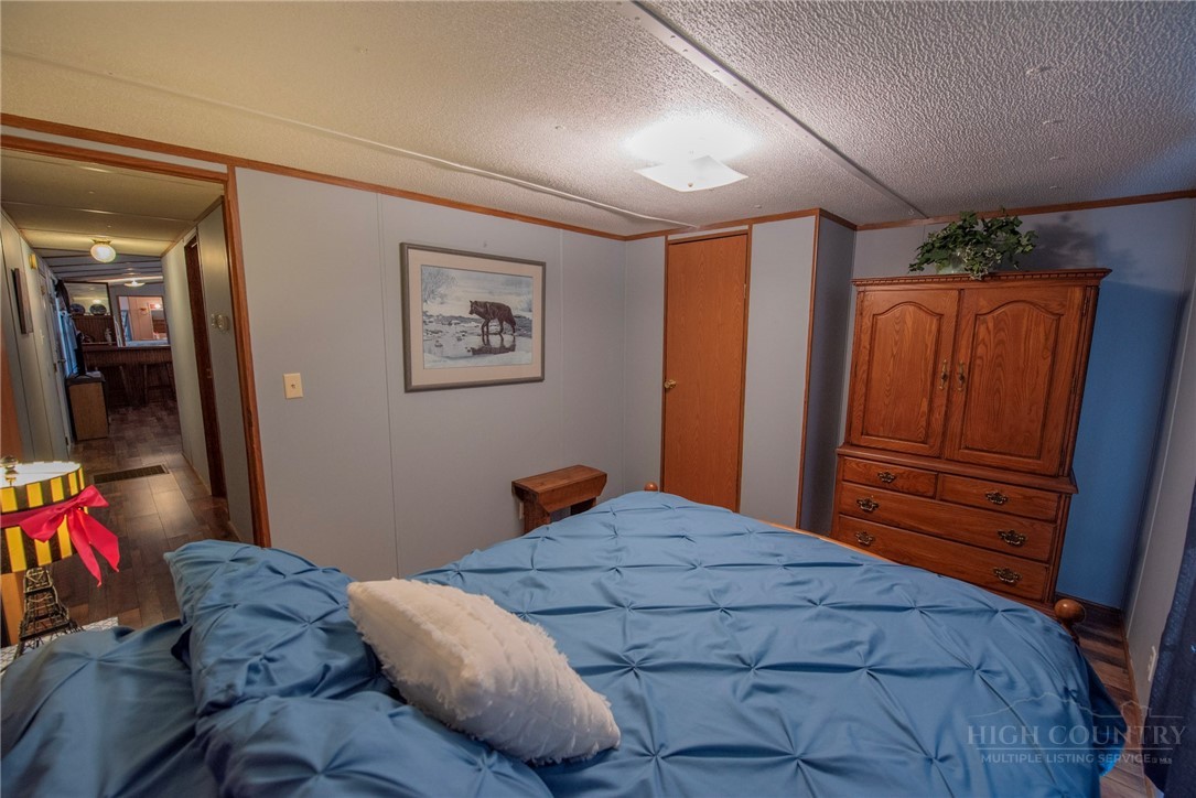 1848 West Mill Creek Road Warrensville, NC 28693 - Photo 38 of 50 a bedroom with a bed and a closet