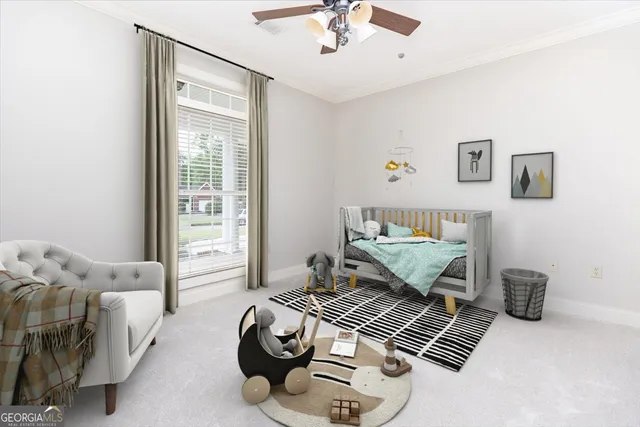 a front view of a house with a garden and trees