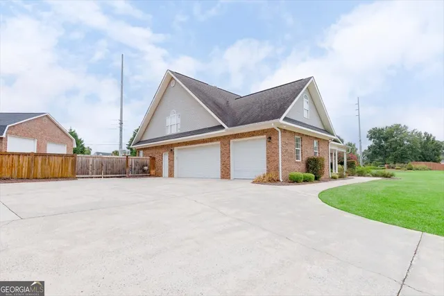 an empty room with ceiling fan and window
