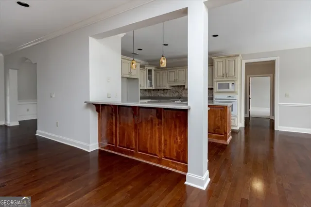 a front view of a house with yard and tree