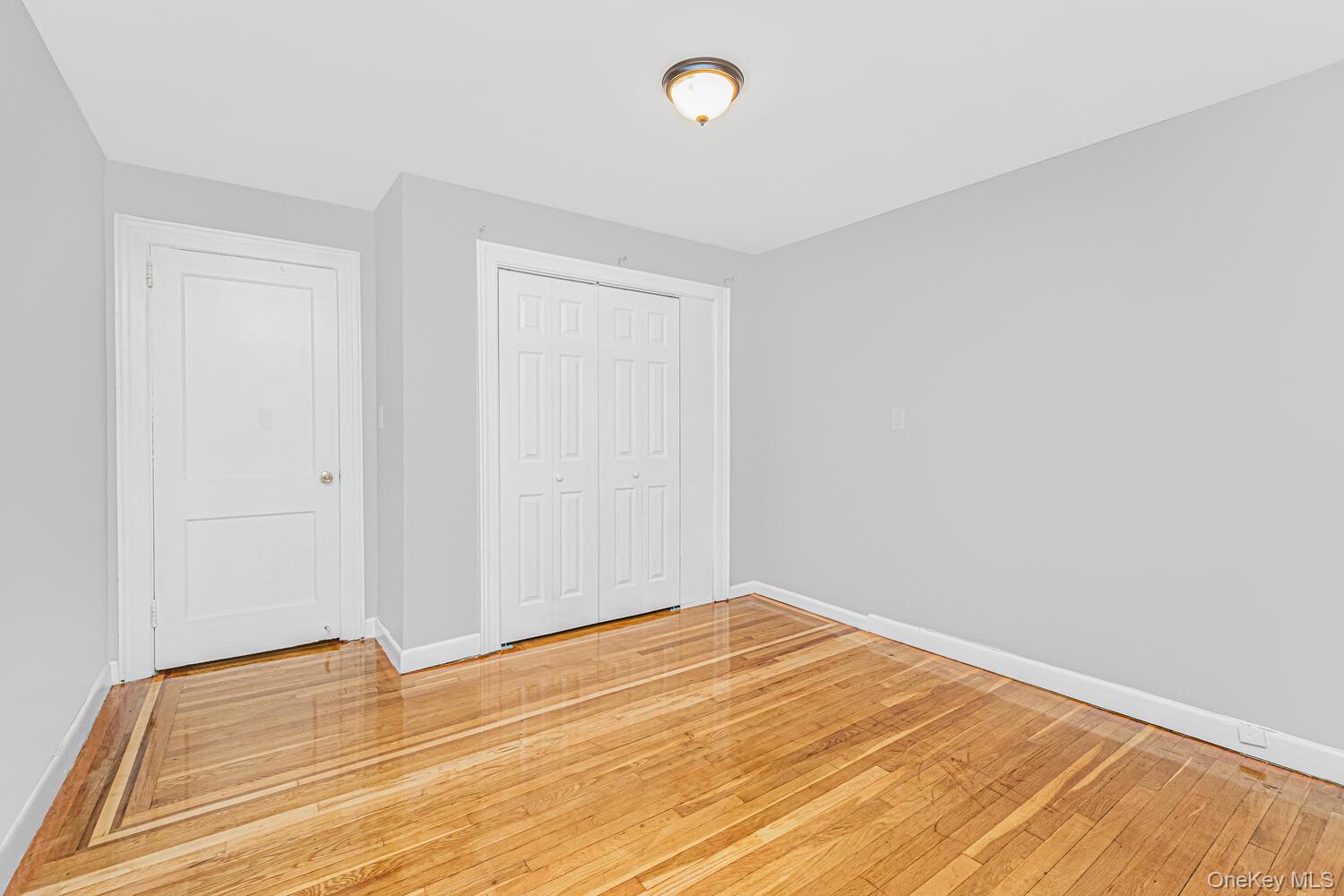 1616 Library Avenue Bronx, NY 10465 - Photo 14 of 20 Unfurnished bedroom featuring light wood-type flooring and a closet
