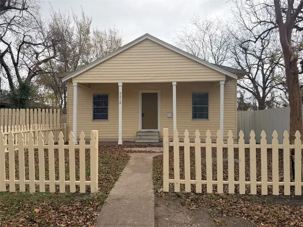 a front view of a house with wooden fence