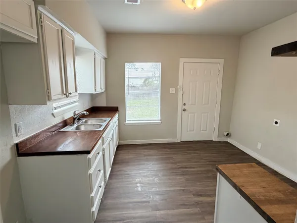 a kitchen with a sink stove and cabinets