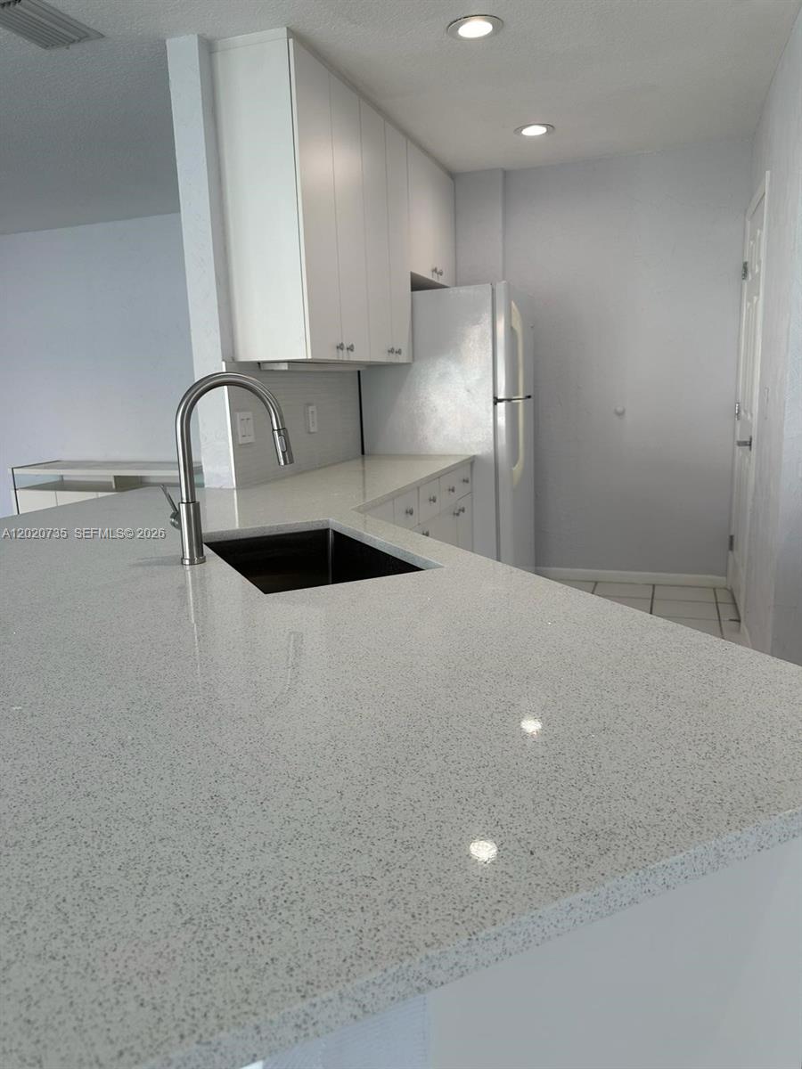 17244 Balboa Point Way Boca Raton, FL 33487 - Photo 7 of 66 a view of a kitchen with a sink and cabinets