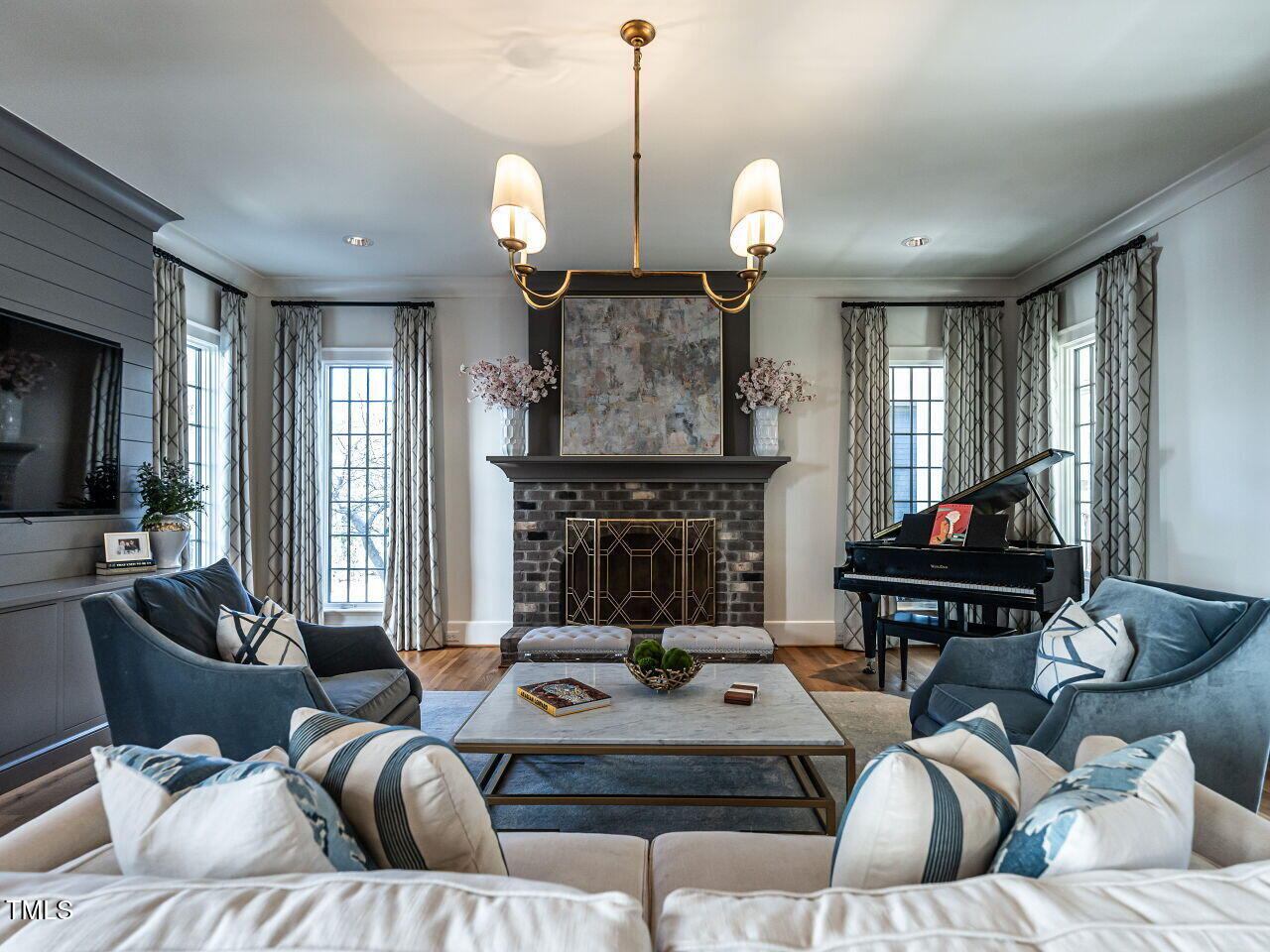 1324 Brooks Avenue Raleigh, NC 27607 - Photo 22 of 65 a living room with furniture a fireplace and a chandelier