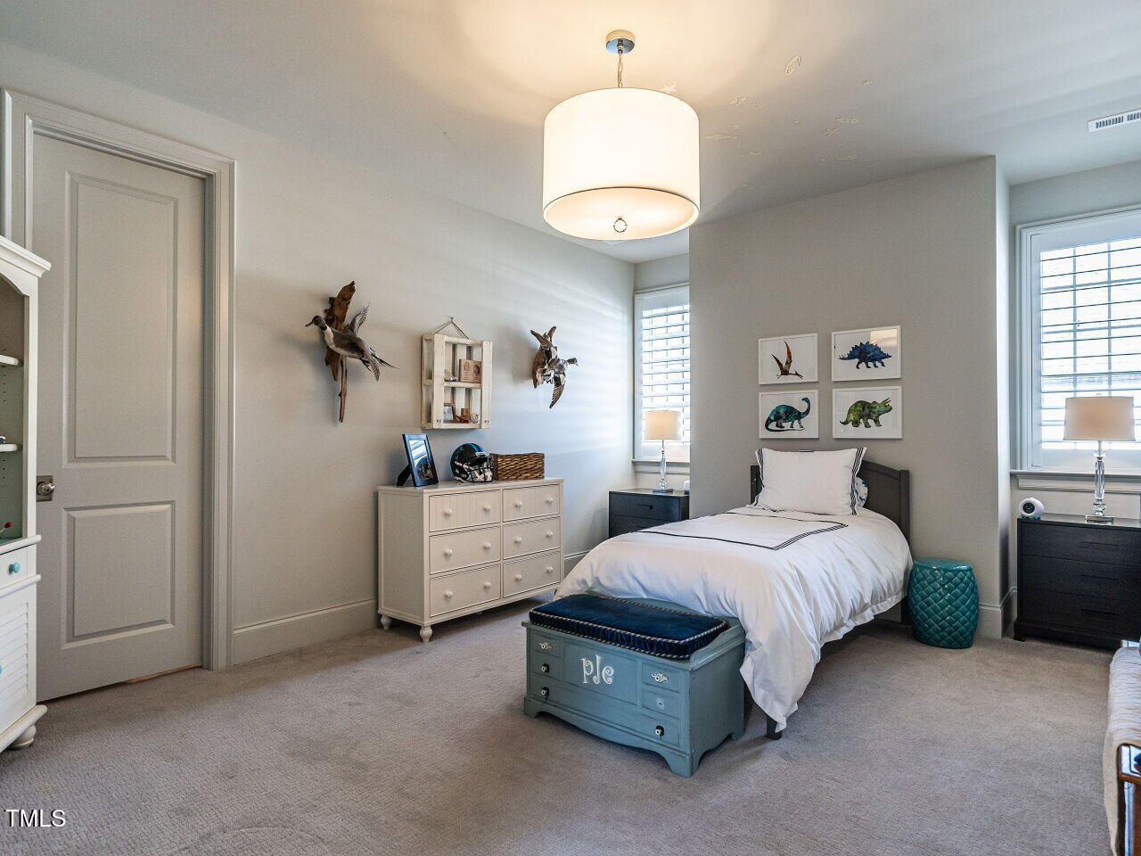 1324 Brooks Avenue Raleigh, NC 27607 - Photo 41 of 65 a bedroom with a bed and a chandelier
