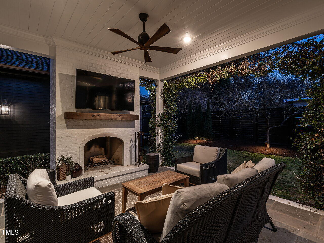 1324 Brooks Avenue Raleigh, NC 27607 - Photo 56 of 65 a living room with furniture a flat screen tv and a fireplace
