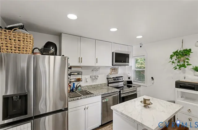 a kitchen with a stove and a white cabinets