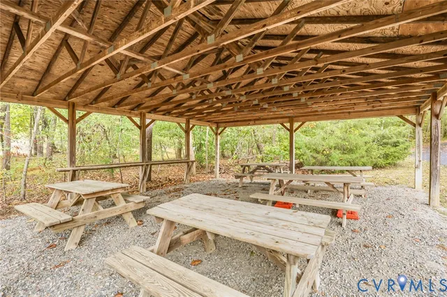 a living room with large windows and furniture