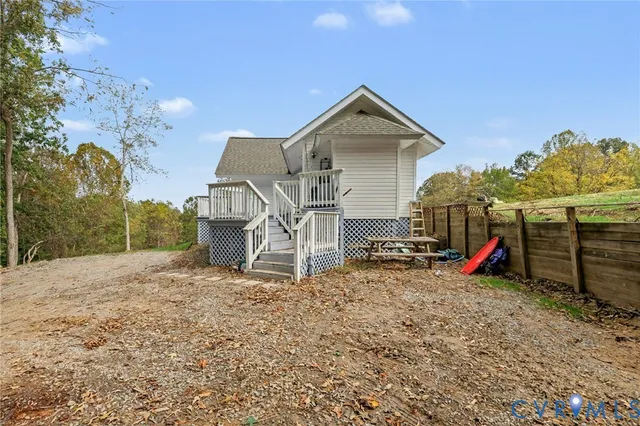 a view of a house with wooden fence